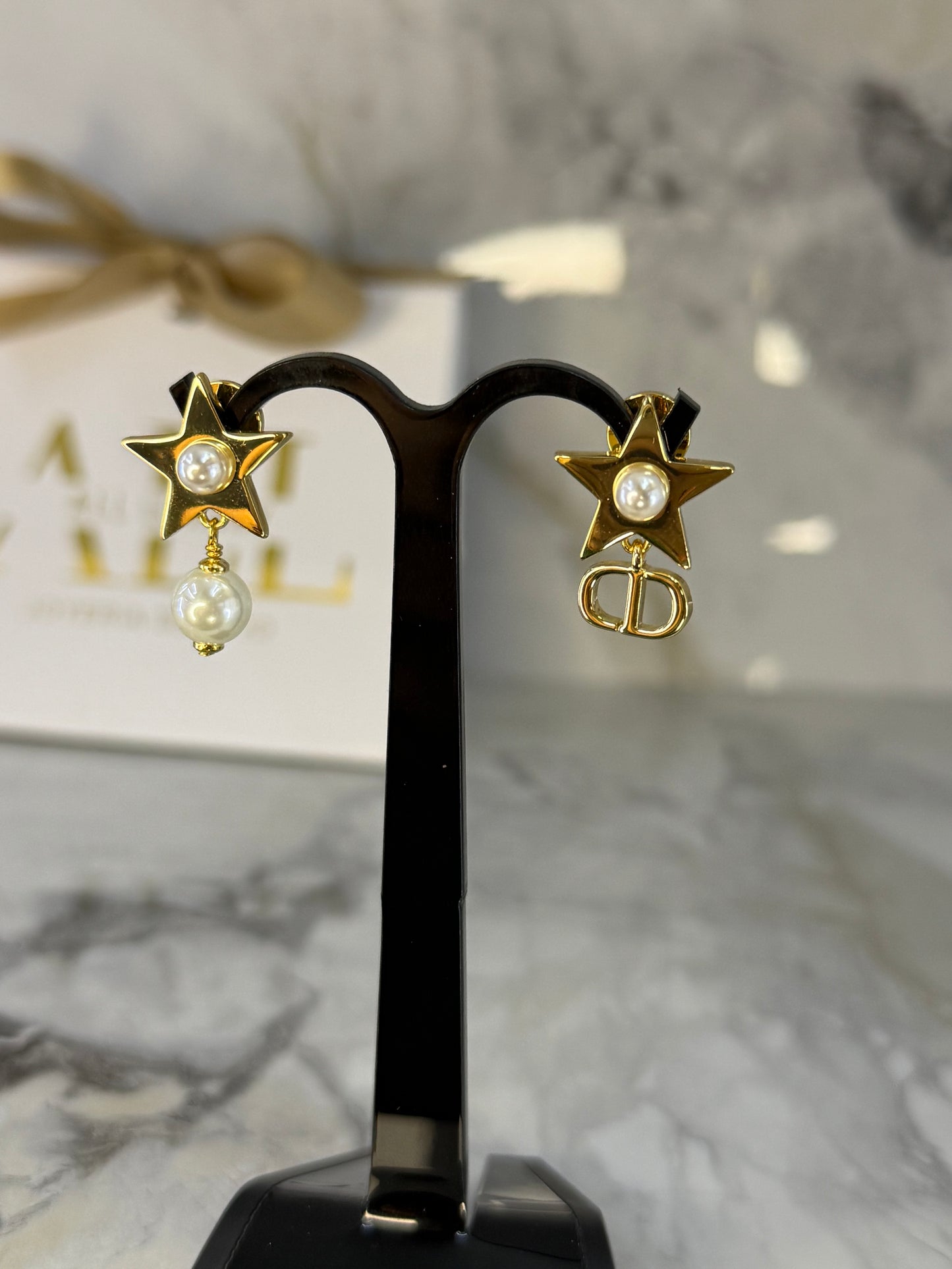 arete asimetrico Dior estrella/perla
